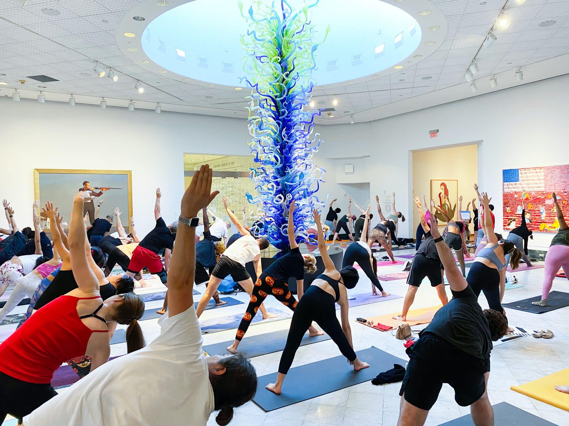 A group of yoga enthusiasts in the gallery