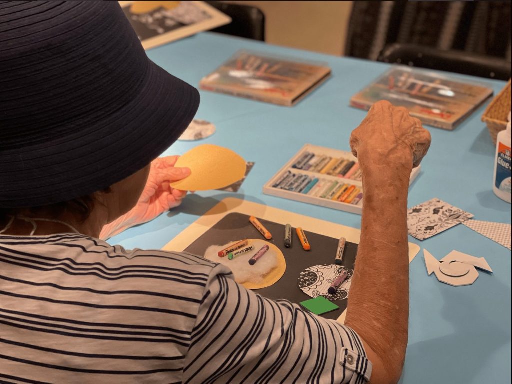 a community member creating art at an Art's the Spark program
