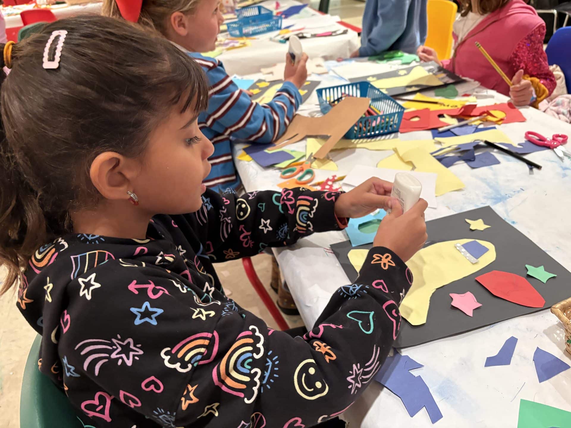 A girl making crafts at a school holiday camp