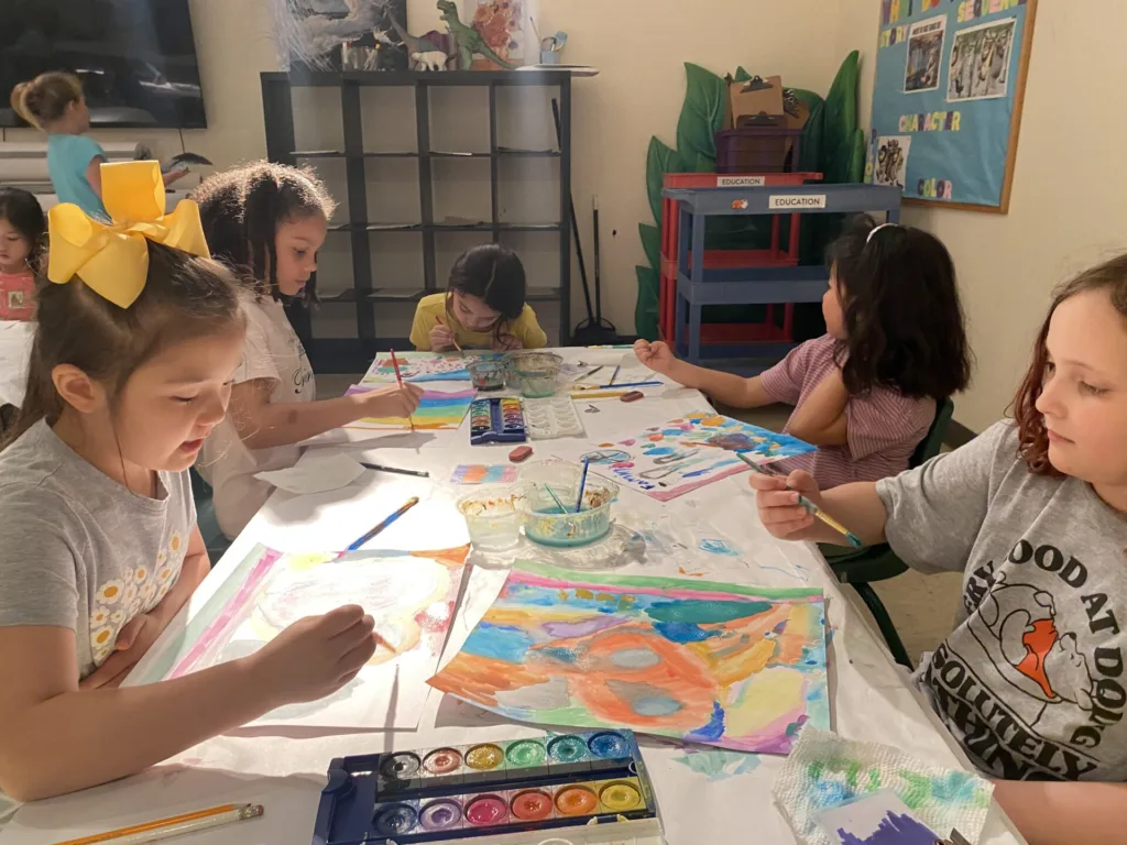 a table of children making art