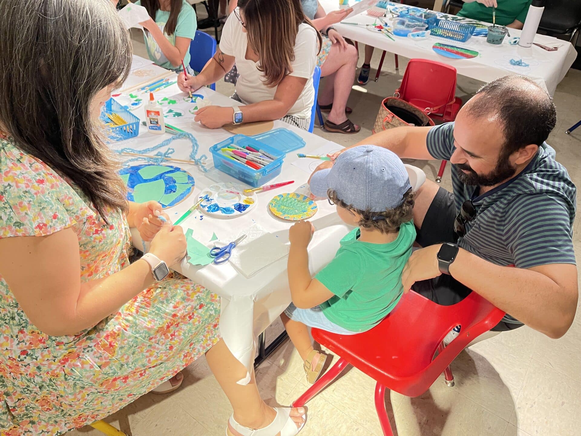 a child with their favorite adults creating art at a family day workshop