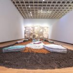 An art installation of concrete, soil, glass, and ceramics.