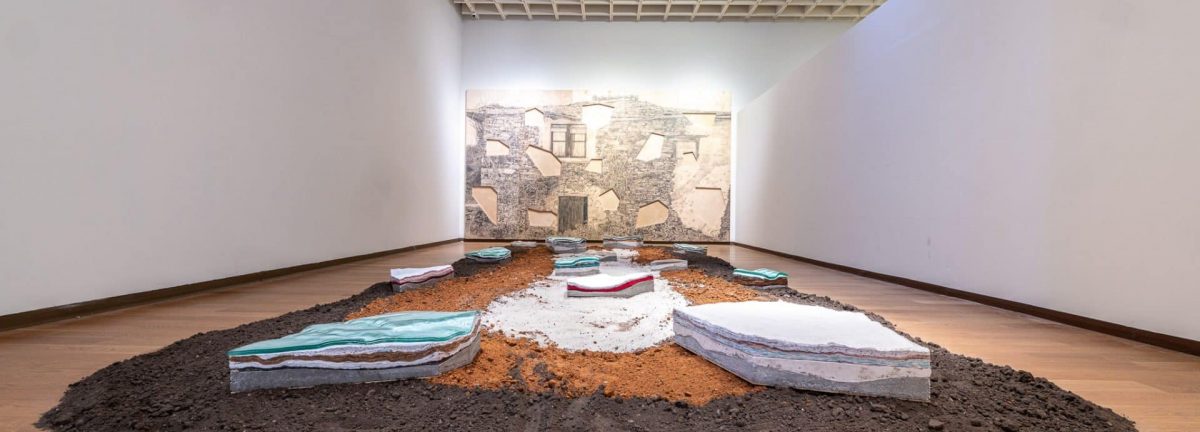 An art installation of concrete, soil, glass, and ceramics.