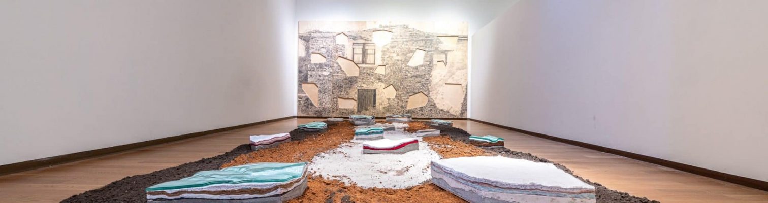 An art installation of concrete, soil, glass, and ceramics.