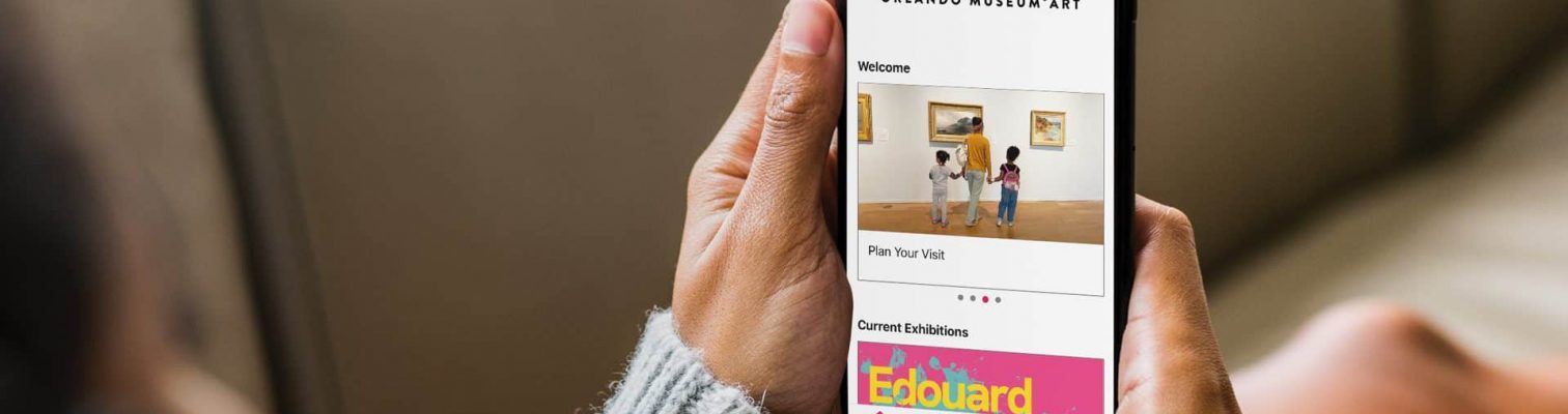 BBGC_Orlando_Digital_phone-in-hand a woman using a phone with the bloomberg connects app