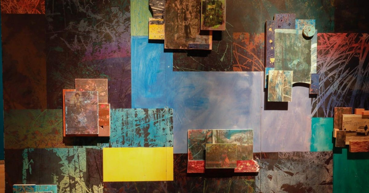 Closeup of colorful paintings and photographs that make up an art installation.