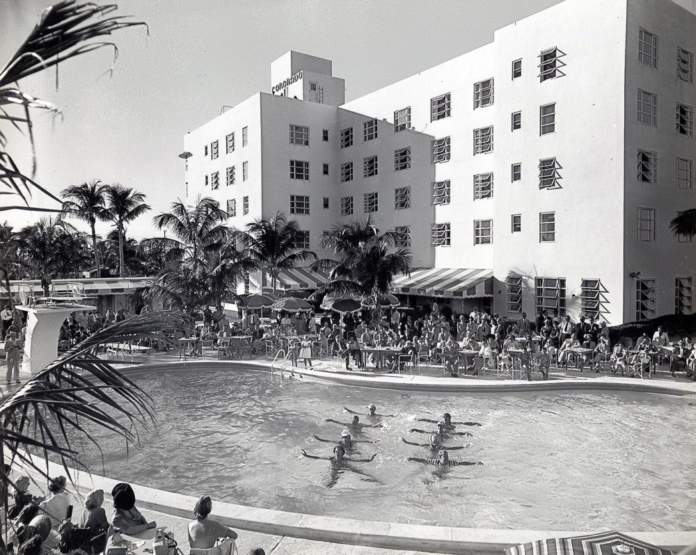 black and white photo of swimmers in a pool at a Miami Beach hotel