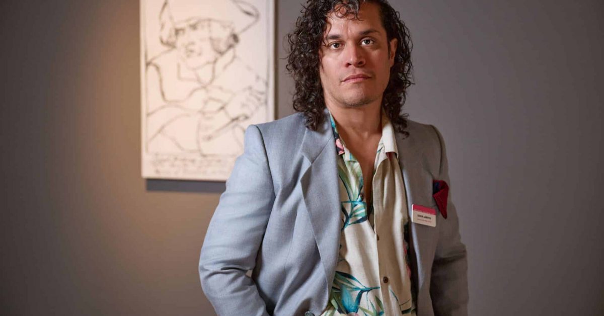 2025 FL Prize artist, Eddie Arroya stands in front of his portrait of Robert-François Damiens