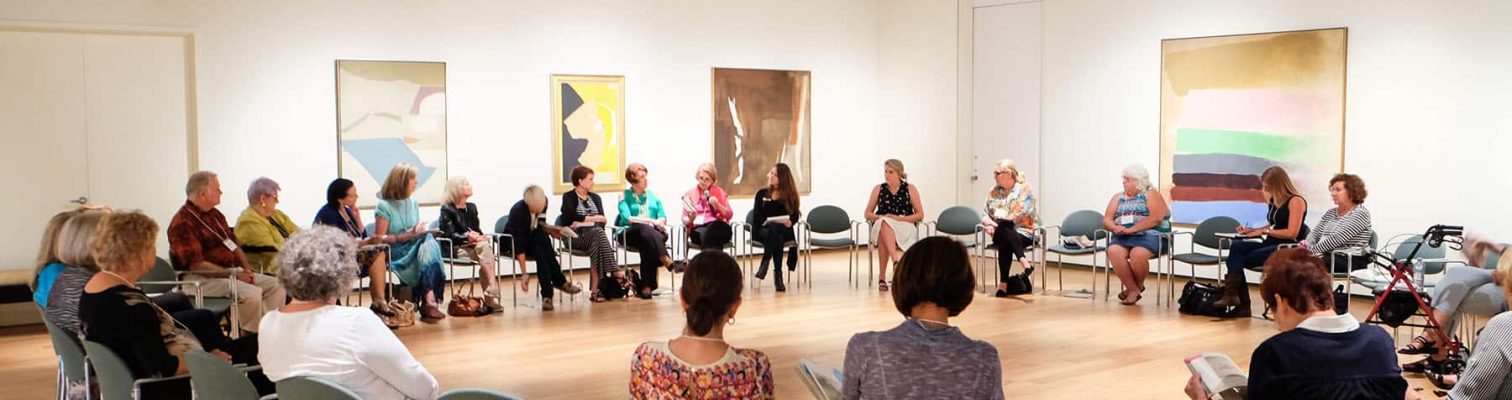 Adults gathered in a circle for the OMA Book Club.
