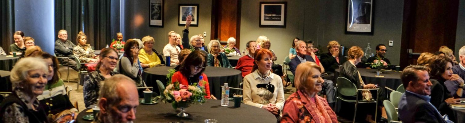 Tables full of visitors enjoying OMA's Art Sandwiched In program.