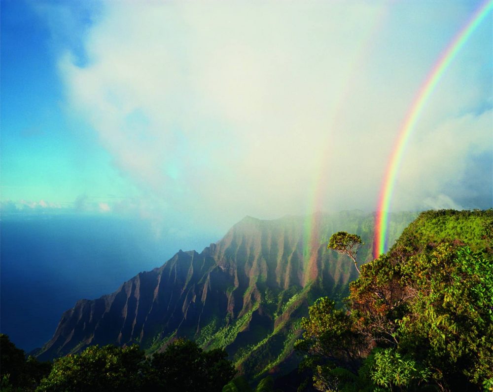 PERMITTED USE: This image may be downloaded or is otherwise provided at no charge for one-time use for coverage or promotion of the National Geographic exhibit "Women of Vision” and exclusively in conjunction thereof.  Copying, distribution, archiving, sublicensing, sale, or resale of the image is prohibited.

REQUIRED CREDIT AND CAPTION: Any and all image uses must  (1) be properly credited to the relevant photographer, as shown in this metadata, and (2) be accompanied by a caption that makes reference to the National Geographic exhibit "Women of Vision.”

DEFAULT: Failure to comply with the prohibitions and requirements set forth above will obligate the individual or entity receiving this image to pay a fee determined by National Geographic.

DIANE COOK AND LEN JENSHEL
A double rainbow arcs above the jagged cliffs and dense vegetation of Kalalau, the largest valley on Na Pali.